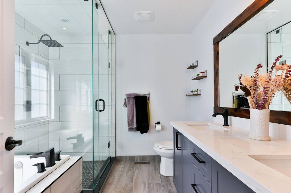 Clean bathroom with sparkling glass shower and polished vanity