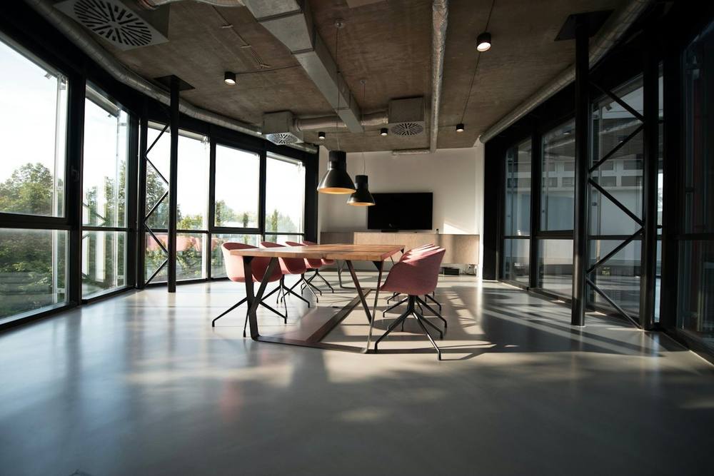 Clean open-plan office with polished concrete floors and large windows
